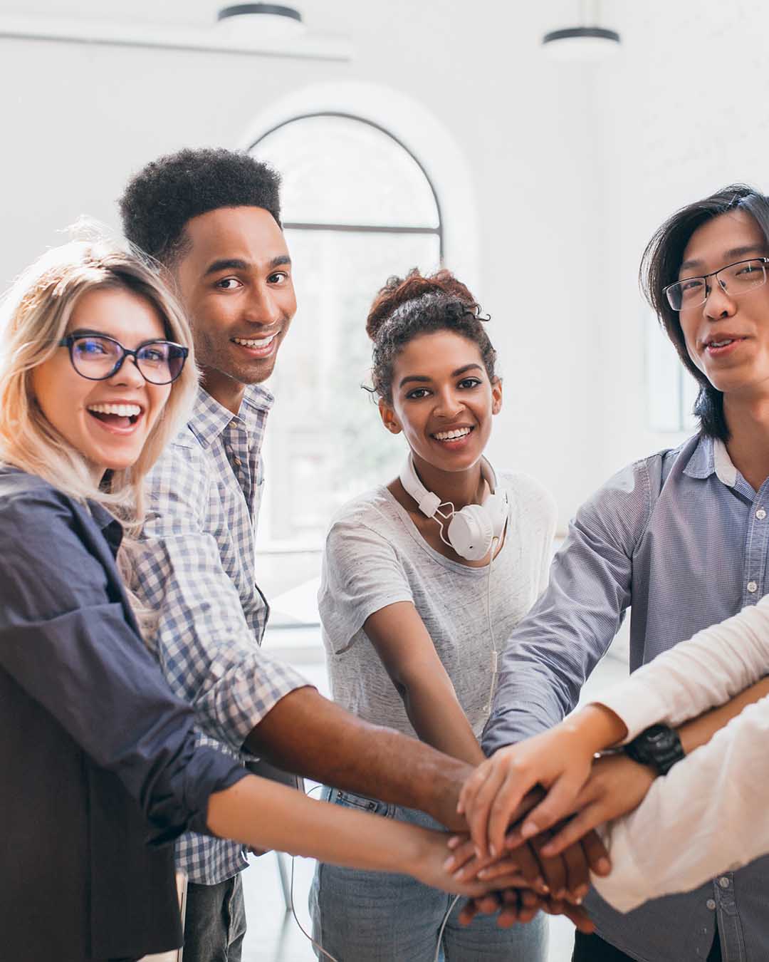 Group of business people with hands piled on top of each other