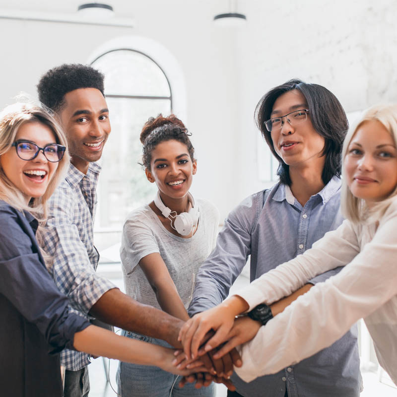 Multicultural Group Joining Hands