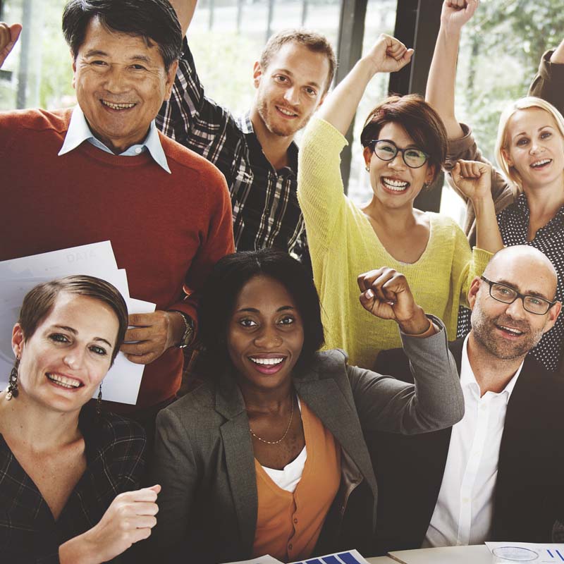 Business team with arms raised