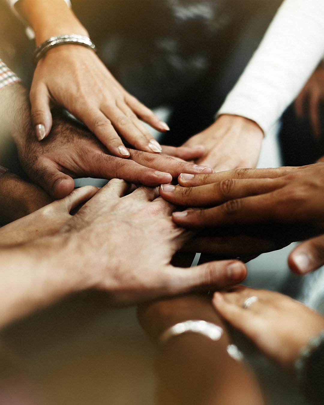 Diverse hands placed on top of each other